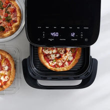 Black infrared air fryer with pizza cooking in the open basket