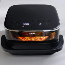 Black infrared air fryer showing 450°F and 12 minutes on the display with cooking inside