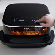 Black infrared air fryer with illuminated touch controls and a hand pressing settings