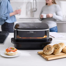 Black infrared air fryer on countertop with closed lid and control panel
