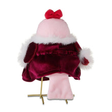 Plush fabric bird in burgundy velvet dress with fluffy white wings and red bow.