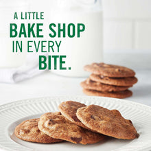Plate of thin crispy chocolate chip cookies with green slogan text on the bag