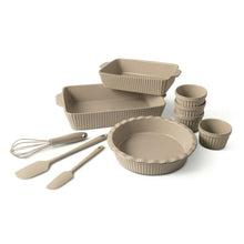 Taupe ceramic bakeware set with ribbed pans, ramekins, whisk, and spatulas