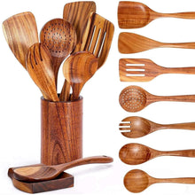 Wooden cooking utensils set in a cylindrical holder, including spoons and spatulas