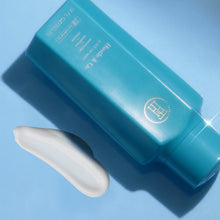 Turquoise TPH Hustle & Co co-wash conditioner bottle with pump, side view