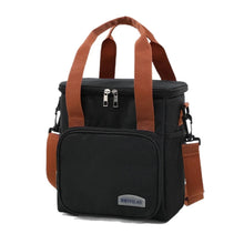 Large canvas tote bag with zip top, front pocket, and adjustable crossbody strap, black with tan handles