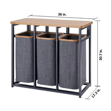 Laundry station with bamboo top, three gray fabric hampers, and gray metal base