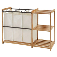 TRINITY bamboo laundry station with hanging white hamper bags and slatted side shelves