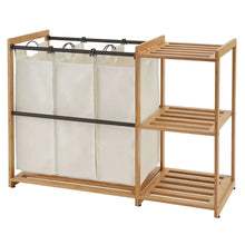 Bamboo laundry station with hanging white bag panels and two-tier wooden shelves