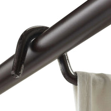 Black metal bar connector with curved end and hanging white laundry bag
