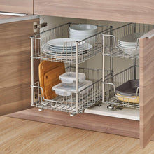 Two-tier wire pull-out drawer with slides in cabinet, holding dishes and containers