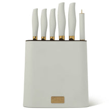 Mint green knife block set with white-handled knives and gold-toned accents