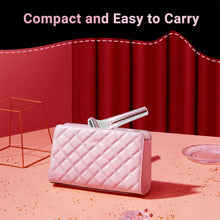 Compact cordless razor with foil head stored in a pink quilted travel pouch
