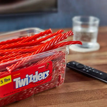 Twizzlers strawberry candy tub with red twist sticks and front label on table