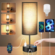 Table lamp with black base and cylindrical fabric shade, warm light and touch dimming.