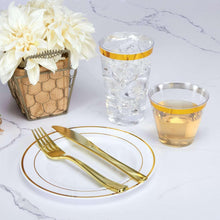 Clear plastic tumbler with gold rim on table setting