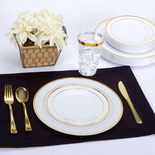 Gold plastic fork, spoon, and knife for table setting with gold-trim accents.