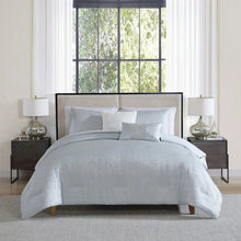 Light grey jacquard comforter set with matching shams and decorative pillows