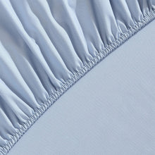 Light blue microfiber fitted sheet edge with gathered elastic detail