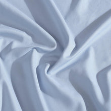Light blue microfiber fabric with soft drape and wrinkles