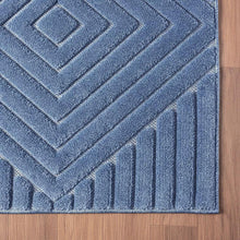 Indoor area rug denim blue with textured raised chevron stripe design