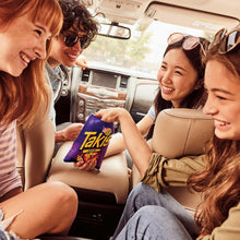 Rolled tortilla chips pack held by people inside a car