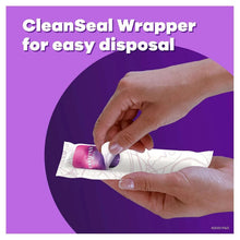 Tampax radiant tampon removed from wrapper by hands
