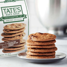 Gluten-free cookies stacked on a plate with a flavor bag for chocolate chip and ginger zinger.