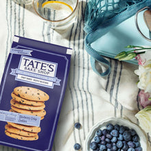 Blueberry crisp cookies bag beside a bowl of blueberries