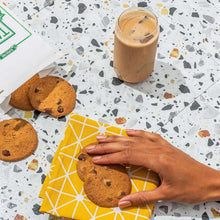 Gluten-free cookie assortment with brown cookies on cloth and hand