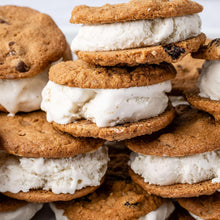 Sandwich cookies with white filling and dark chocolate chips, stacked close-up