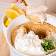 Gluten-free cookie bite with white icing and mint, served with lemon slices.