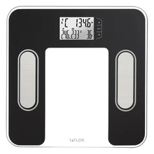 Body composition scale with backlit LCD and four electrode pads, black and white.