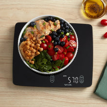 Black digital kitchen scale with a bowl on top and illuminated display