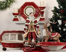 Red and gold pillar candleholder set with white pillar candles and holiday decor