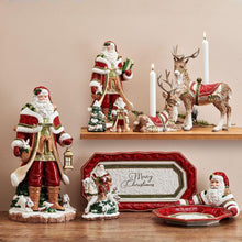 Standing deer candle holder with red saddle and two lit candles