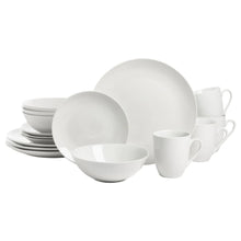 White ceramic coupe dinnerware set with stacked bowls, plates, and mugs.