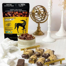 Organic pitted dates pouch with dates and rolled sweets on a table