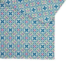 Teal, blue, red, and green patterned kitchen towel with repeating floral tile motifs.