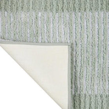 Textured stripe microfiber bath rug corner with cream backing and vertical stripe texture