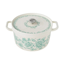 Green floral enameled cast iron Dutch oven with matching lid and side handles