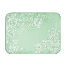Green dish drying mat with white floral pattern, bordered frame, rectangular shape