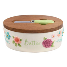 Floral ceramic butter dish with acacia wood lid and green-handled serving knife