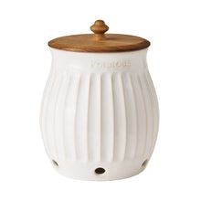 White stoneware potato keeper jar with ridged sides and wooden knob lid
