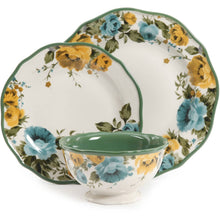 Floral dinner plate set with green border and blue/yellow rose pattern