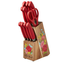 Red-handled knife set standing in acacia wood block with floral panels