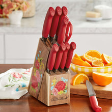 Red-handled knives in an acacia wood knife block with floral artwork