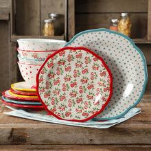 Dinner plate with cream base, red floral center, and blue dotted outer rim
