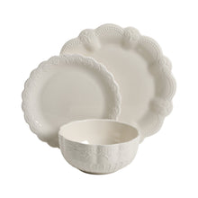 Scalloped white dinner plates and matching bowl with embossed floral texture