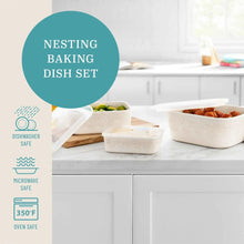 Nesting baking dish set with cream lace dishes and lids on countertop
